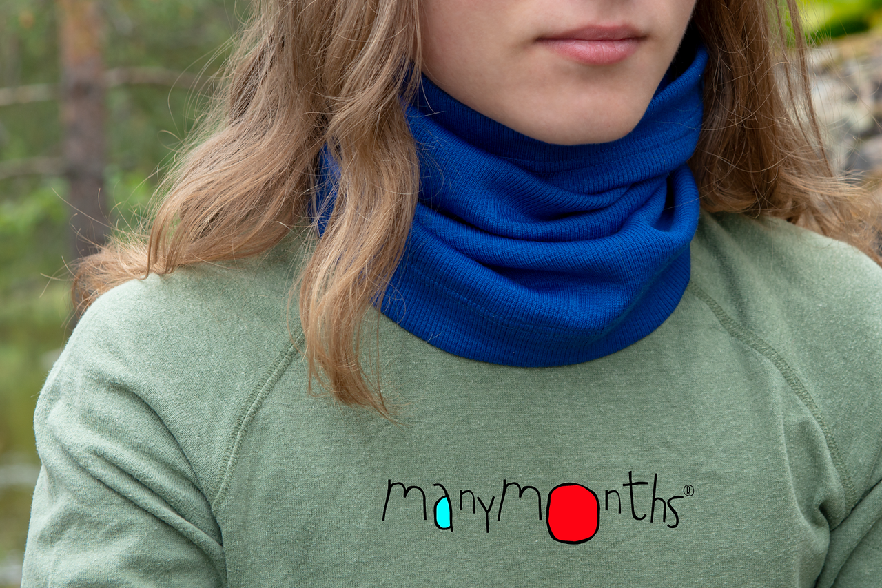 woman wearing a blue merino wool neck warmer by brand 'manymonths'