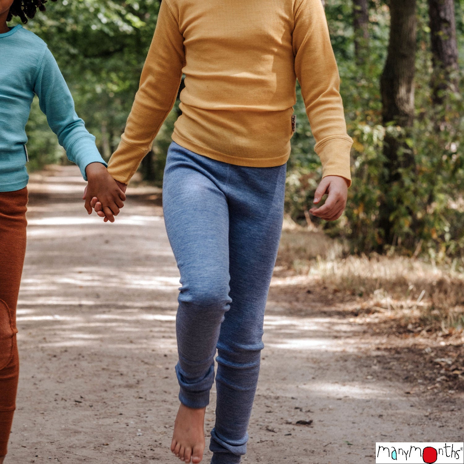 child walking holding hands in merino wool leggings with ribbed fabric durable in blue with foldable cuffs and adjustable elastic waist in woods