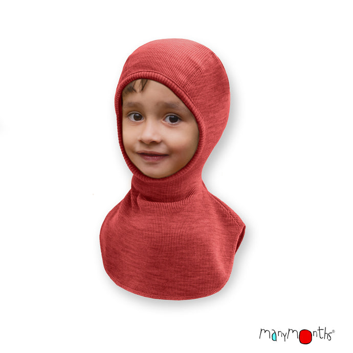 child wearing pink merino wool balaclava with 'manymonths' branding