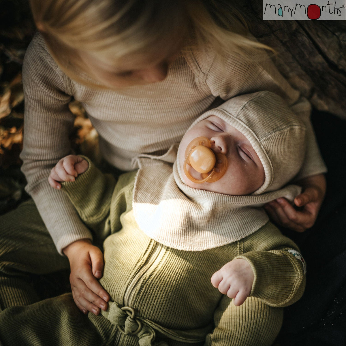 snug fitting full coverage merino wool kids balaclava in a warm cream oatmeal melange color by manymonths on an infant